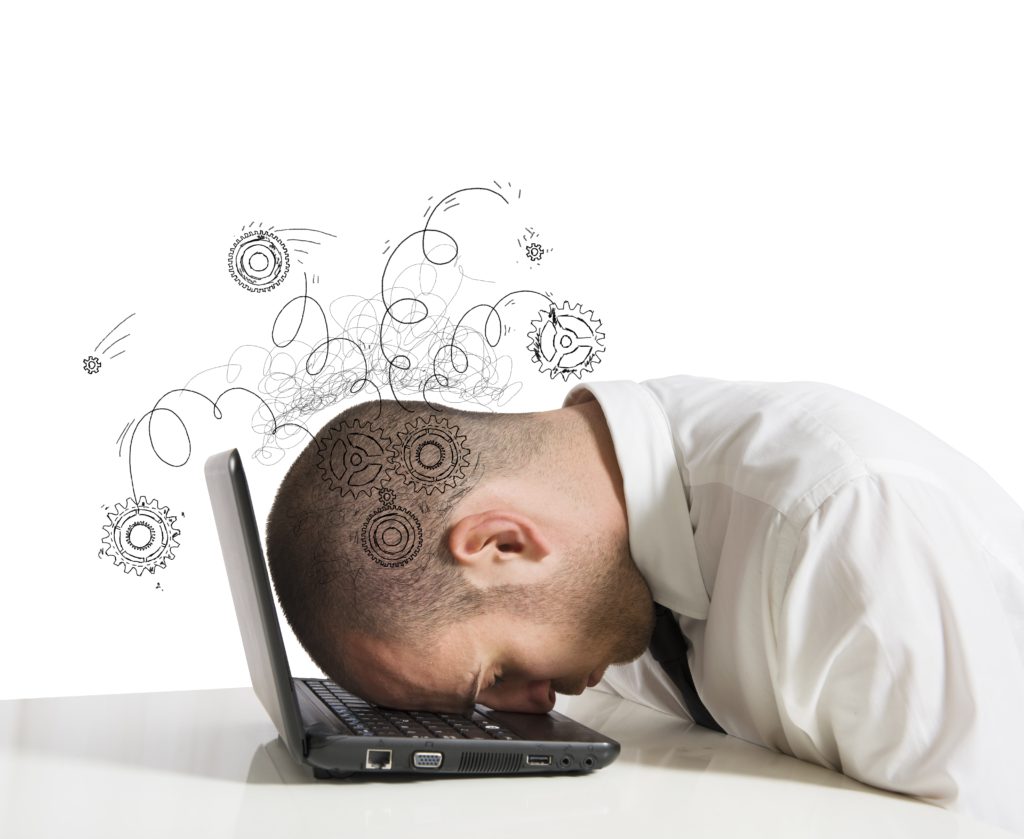Concept of stress in the work place with businessman sleeping on a laptop