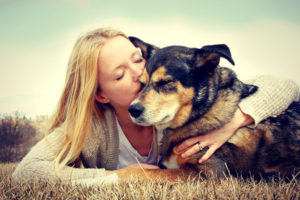 National Hug Your Hound Day - Woman hugging German Shepard dog.