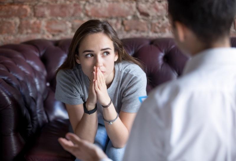Young girl with anxiety speaking with a therapist
